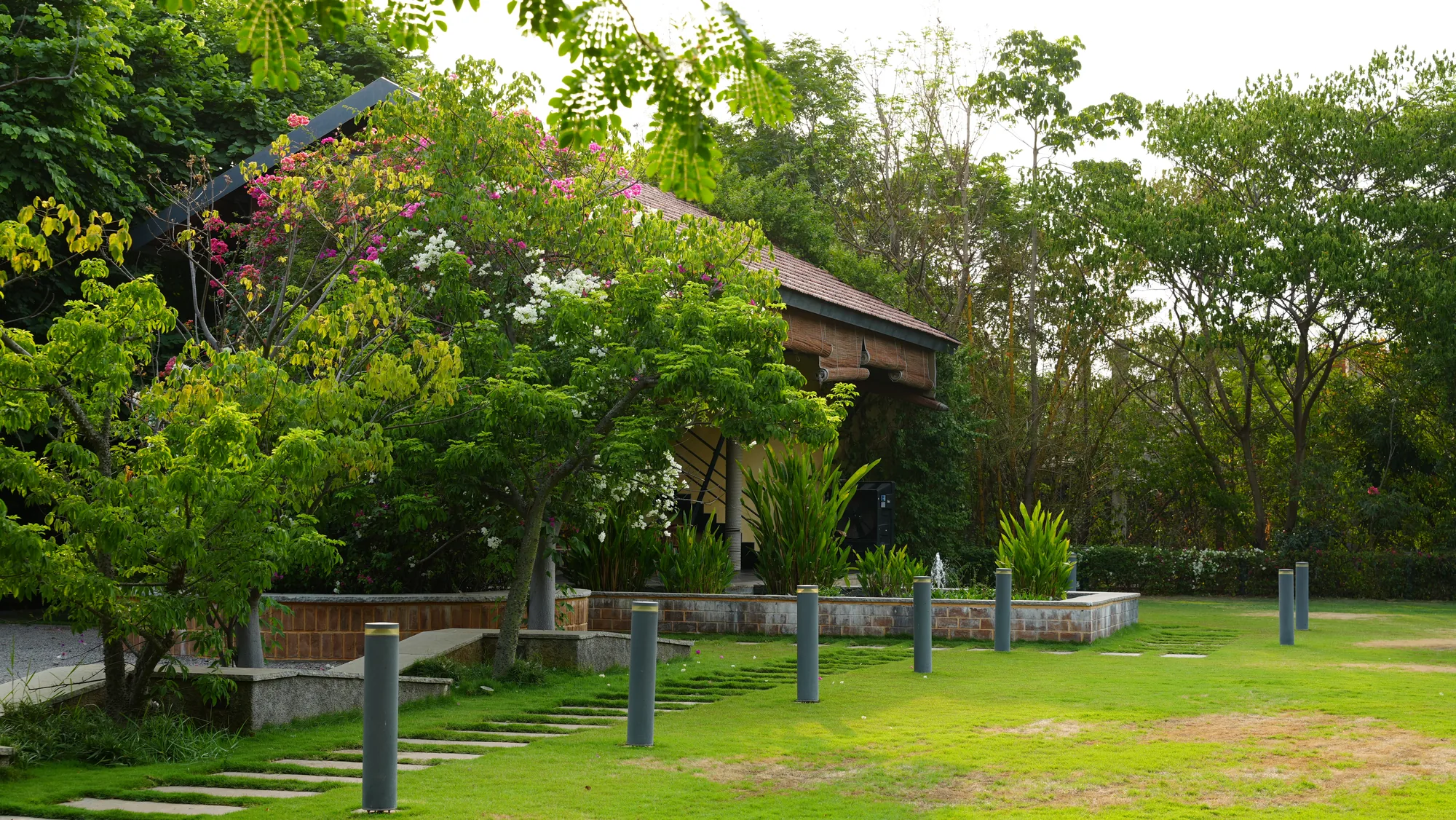 Pavilion and lawn with stepping stones at Woods Shamshabad, Hyderabad